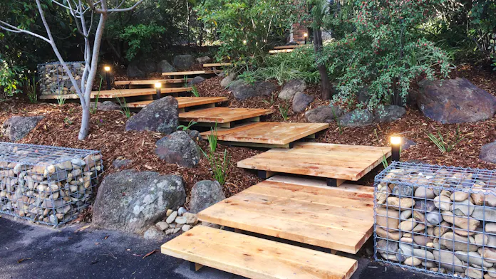 Front entrance in Eltham, Melbourne fully landscaped by Land Sculpture with a series of timber boardwalks and landings through the front garden
