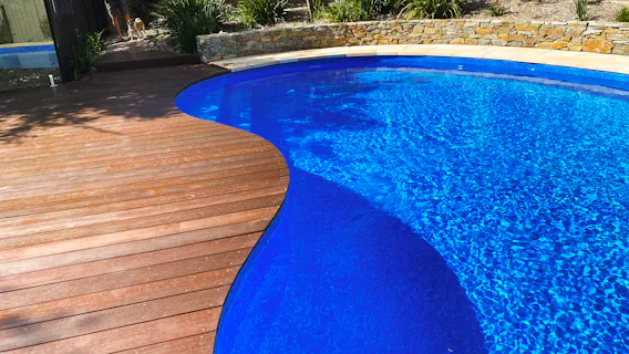 Eltham, Melbourne landscaping with timber pool decking and rock wall