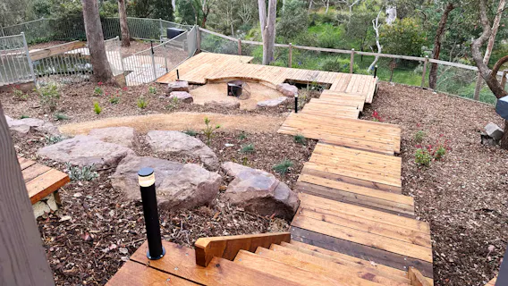 Eltham, Melbourne home with renovated backyard including timber boardwalks down through a newly installed low maintenance garden overlooking the Diamond Creek by Land Sculpture