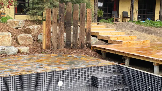 Hurstbridge, Melbourne luxury outdoor pool area being fully landscaped by Land Sculpture including timber decking, paving and privacy screening